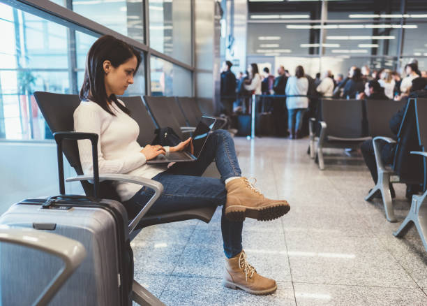 istock Passenger at the airport using laptop 1148848302