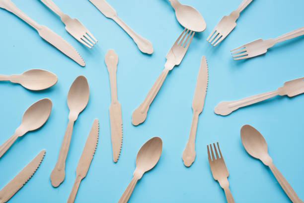istock Disposable tableware from natural wooden materials, spoon, knife, and fork, eco-friendly for picnic on blue. Top view. 1148848458