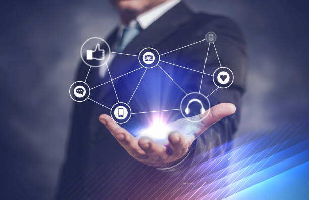 istock businessman network icon on his hand and on dark background 1148848485