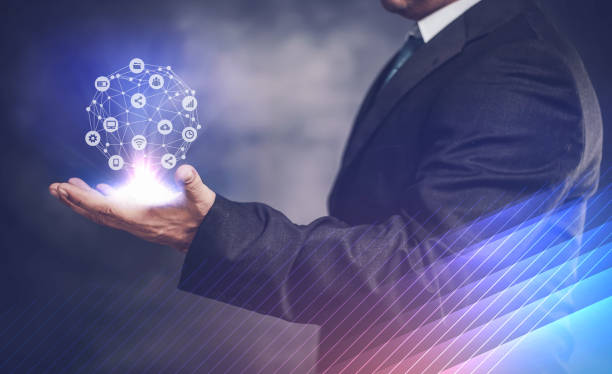 istock businessman network icon on his hand and on dark background 1148848578