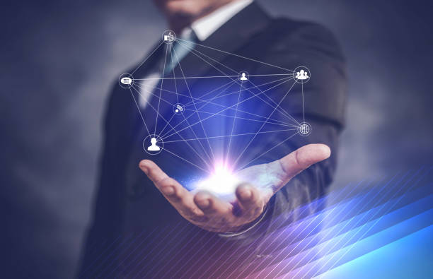 istock businessman network icon on his hand and on dark background 1148848797