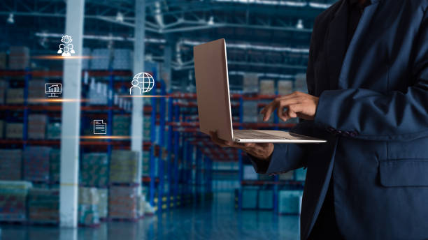 istock Businessman manager using laptop check orders online goods worldwide for network with Modern Trade warehouse logistics. Industry of logistics network concept. 1148850805
