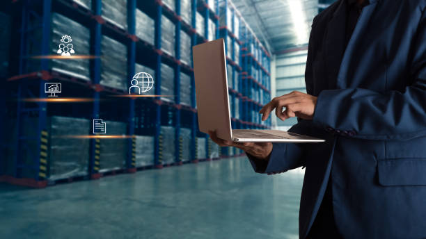 istock Businessman manager using laptop check orders online goods worldwide for network with Modern Trade warehouse logistics. Industry of logistics network concept. 1148850806