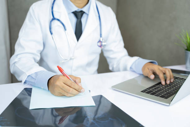 istock Asian doctor works at the computer in clinic office - Image 1148851084