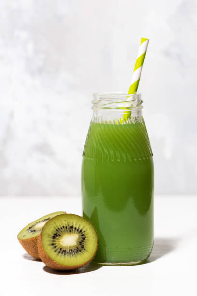 istock green kiwi juice in a bottle, vertical closeup 1148851474