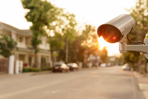 CCTV surveillance camera operation in village with house and cars stock photo