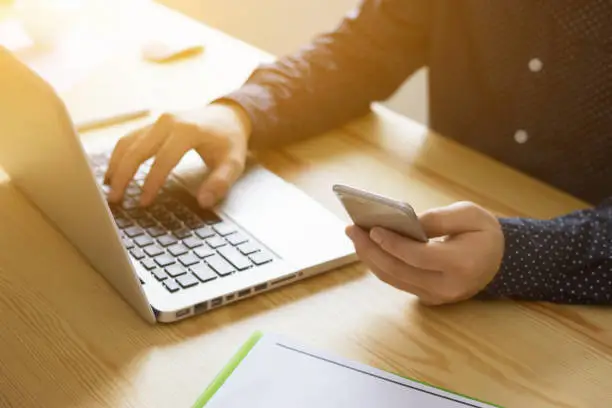 Photo of businessman working with modern laptop devices, student using digital tablet computer and mobile smart phone,business concept,selective focus,vintage color