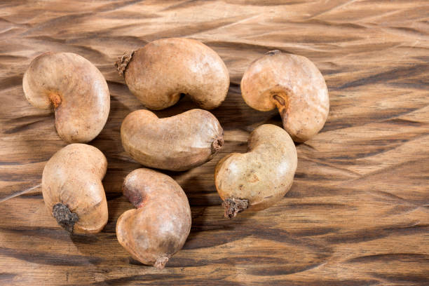 istock Cashew nuts on wooden background - Anacardium occidentale 1148854016
