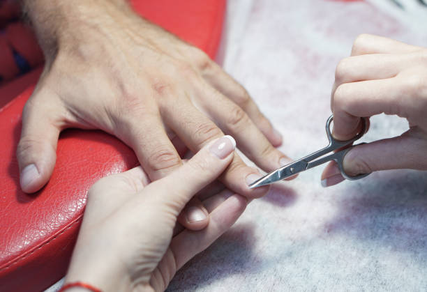 Nail scissors in the hands of a professional. Salon Crassot. man hands in the process of work. Fashionable beauty theme. Stock photo stock photo