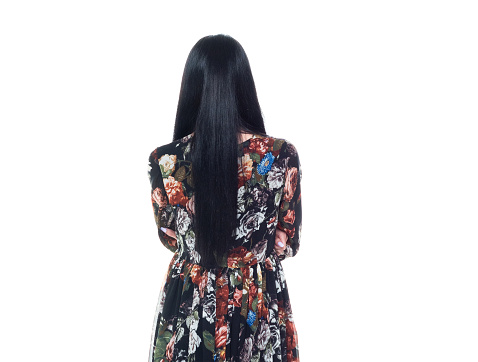 Attractive tall female wearing a floral dress - arms crossed