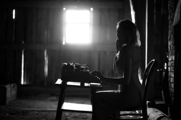 istock A girl prints on an old typewriter 1148859581