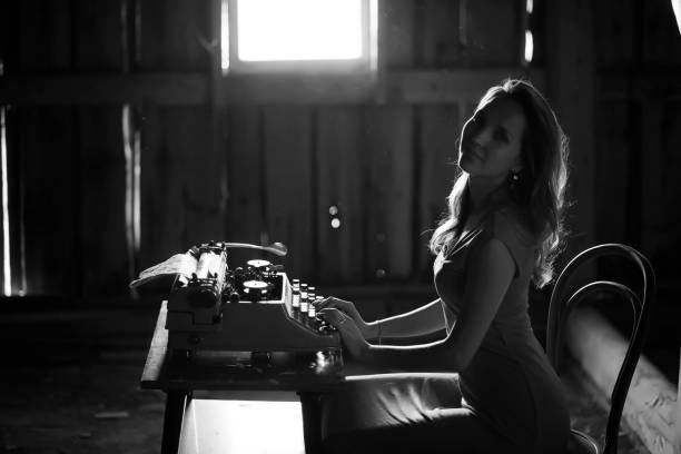 istock A girl prints on an old typewriter 1148859640