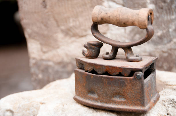 istock Ancient metal iron with wooden handle 1148859646