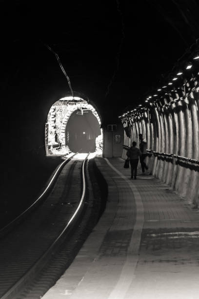 istock silhouettes in tunnel, black and white 1148861069