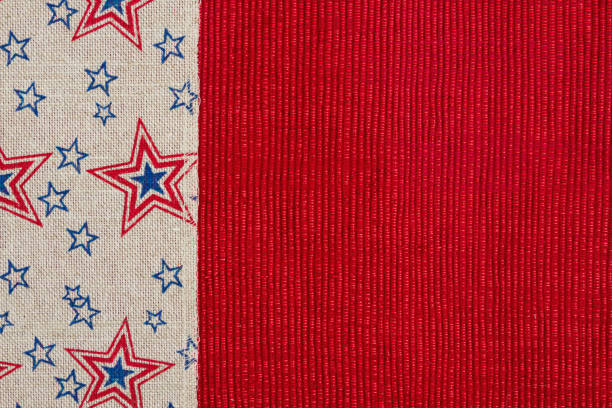 istock Red and blue star burlap ribbon on a shiny red material 1148861189