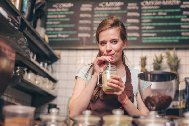 istock Young attractive girl drinking smoothie 1148861256