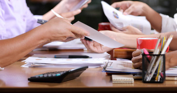 istock Asian businesswomen analysis documents on office table with laptop computer and graph financial diagram working in the background 1148864892