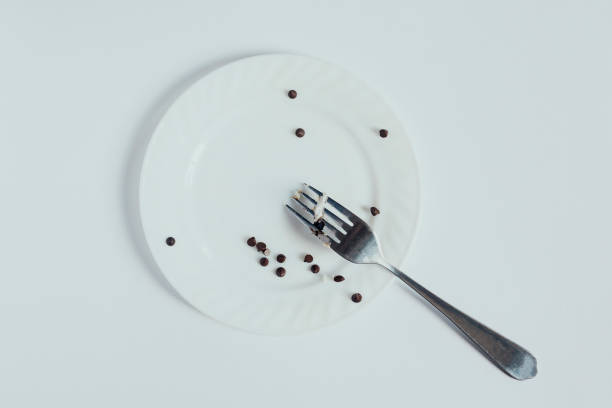 istock Empty and dirty white dish and fork after eating dessert. Dieting problems. Can't stop eating sweets 1148864893