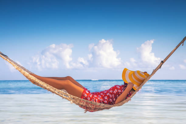 girl relaxing in a hammock on tropical island beach. summer vacation in punta cana, dominican republic - hammock beach vacations tropical climate imagens e fotografias de stock