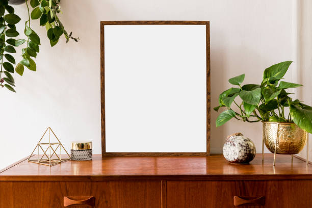 istock Nice and retro space of home interior with mock up poster frame, vintage cupboard with elegant gold accessories, plants in stylish pots. Cozy home decor. Minimalistic concept. Template. Real photo. 1148867200