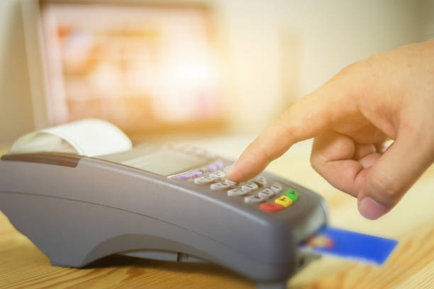 istock hand using credit card swiping machine entering credit card code to pay shopping online.creditcard swipe through terminal for payment in shop,buy and sell products & service,internet of things,vintage 1148867427