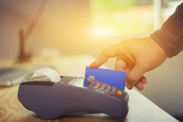 istock hand using credit card swiping machine entering credit card code to pay shopping online.creditcard swipe through terminal for payment in shop,buy and sell products & service,internet of things,vintage 1148867452