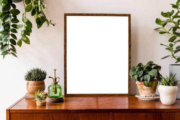 istock Nice and retro space of home interior with mock up poster frame, vintage cupboard with elegant floral accessories, a lot of plants in stylish pots. Cozy home decor. Minimalistic concept. Home garden 1148867471