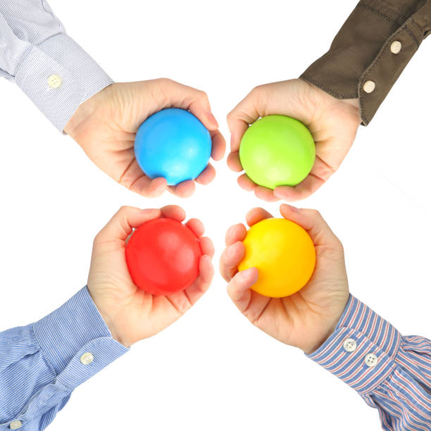 istock Men's hands with colorful plastic balls on white background 1148868356