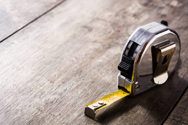 Measuring tape on wooden table Measuring tape on wooden table tape measure photos stock pictures, royalty-free photos & images