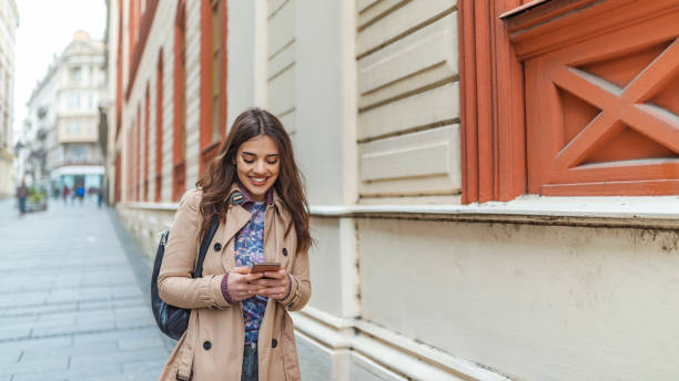 istock Woman using smartphone on the street 1148868536