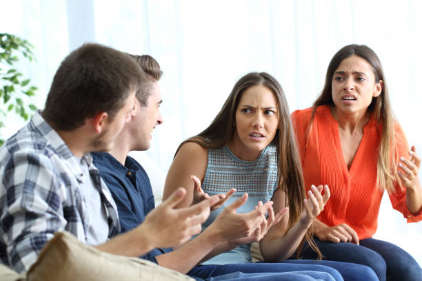 istock Four angry friends fighting at home 1148871462