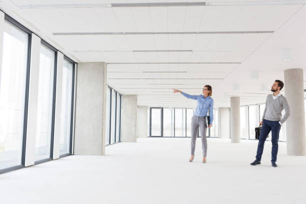 istock Professional colleagues discussing in empty new office 1148873970
