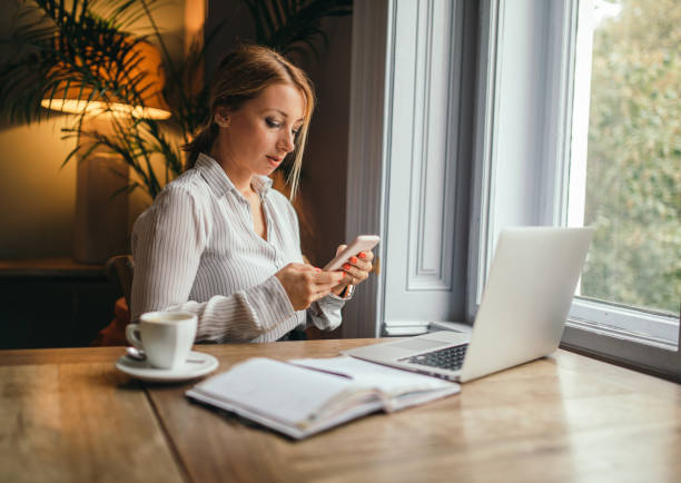 istock Attractive woman using cell phone to schedule a meeting 1148874196