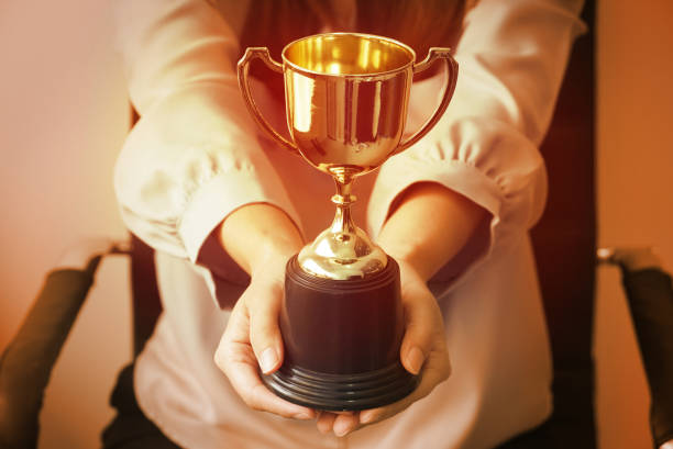 istock Warm theme business woman give trophy,win concept. 1148874269