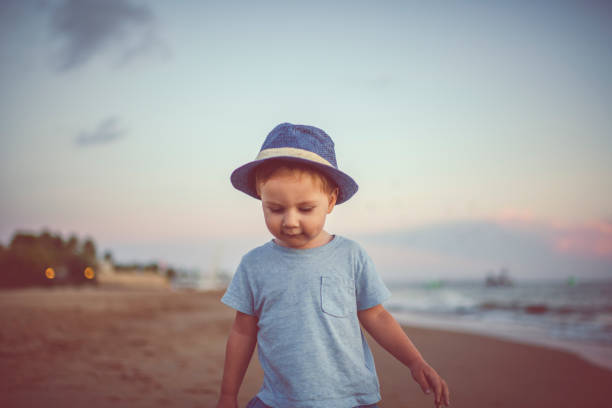 Happy child enjoying sunset near the sea