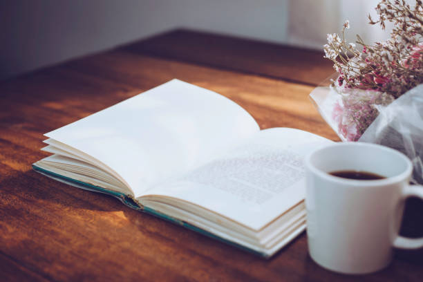 istock old book and  a cup  of coffee over flowers  on table 1148875929