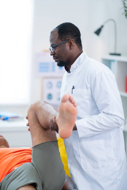 istock Sportsman in grey shorts lying while visiting therapist 1148876736