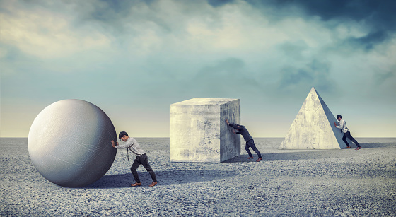 Businessman pushing the round large stone. Business heavy tasks and problems concept. differentiation between work