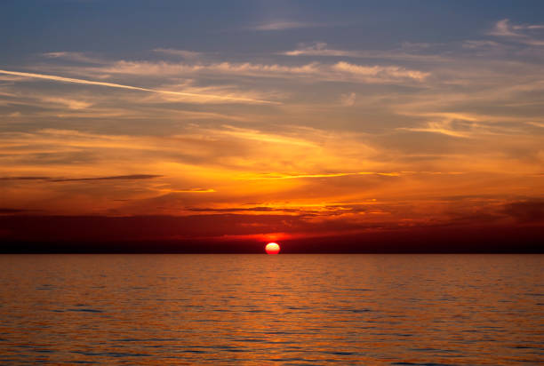 istock Sun touching the horizon at dusk 1148880218