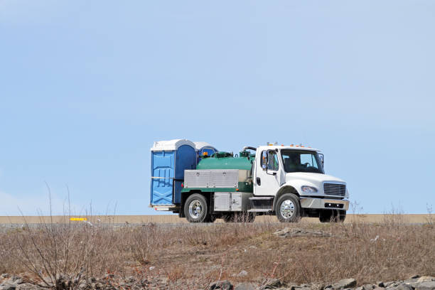 istock Truck On Highway Transporting Portable Toilets 1148882627