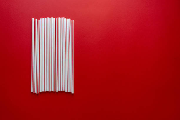istock Colorful straw cocktail on red background 1148883928