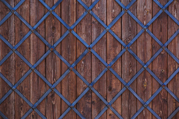 Wooden background with a metal grid closeup