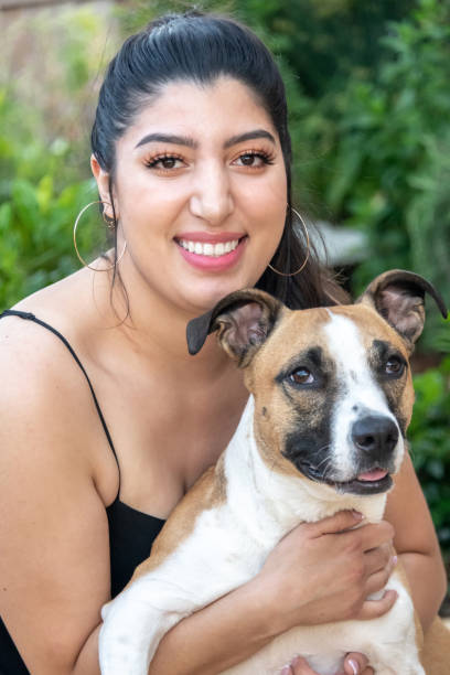 istock Hispanic young woman posing with her dog 1148886330