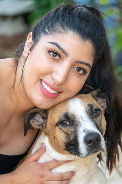 istock Hispanic young woman posing with her dog 1148886421
