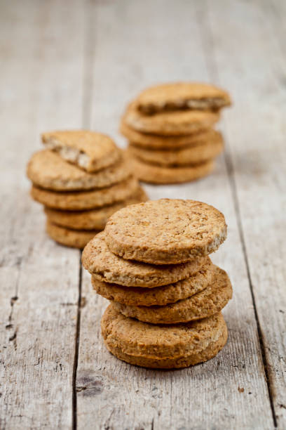 istock Three stacks of fresh baked oat cookies on rustic wooden table. 1148888642