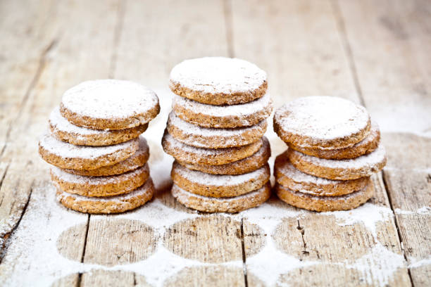 istock Fresh oat cookies stacks with sugar powder on rustic wooden table background. 1148888945