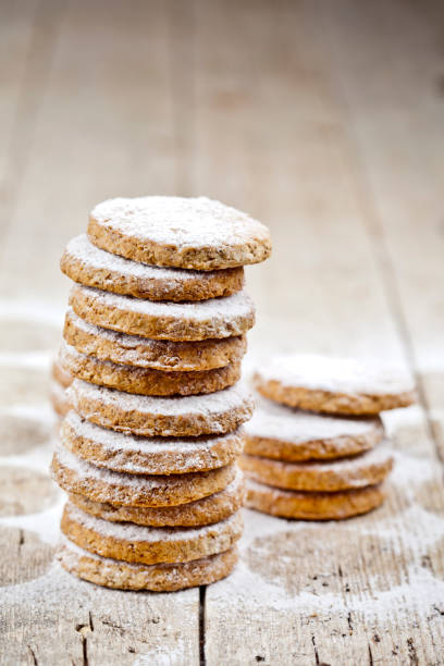 istock Fresh oat cookies stacks with sugar powder on rustic wooden table background. 1148888967