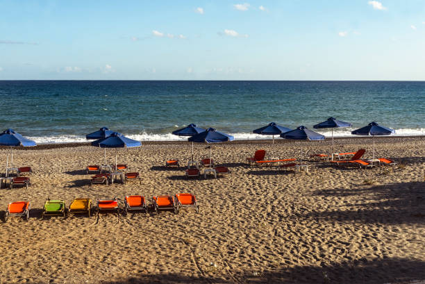 istock view Cretan beach in summer with umbrellas 1148891055