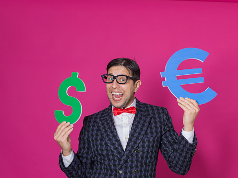 Nerd man holding dollar and euro signs