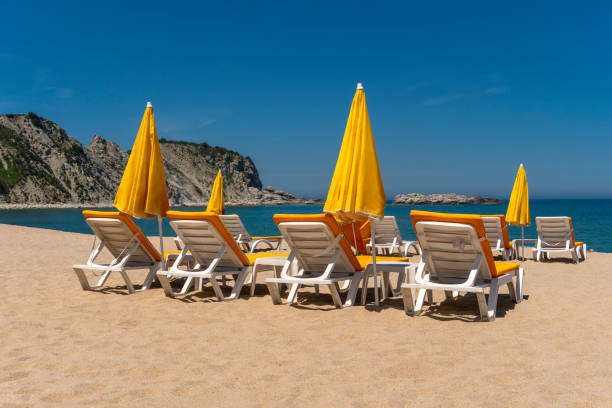 istock Sun lounges and beach umbrellas on a beach. 1148892631